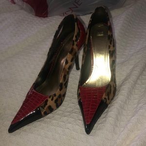 Man made leopard print, black, and red heels.